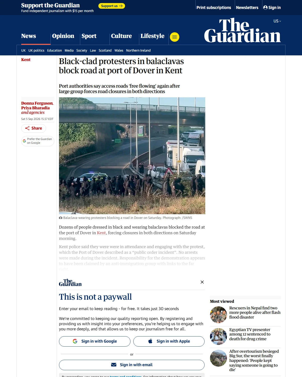 theguardian.com as published: Black-clad protesters in balaclavas block road at port of Dover in Kent